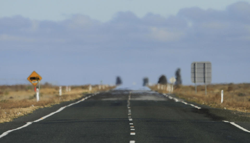 In this May 25, 2013 photo the Outback landscape is shown on the Sturt Highway near Wentworth, 1,043 kilometers (648 miles) from Sydney, Australia, during a seven-day, 3,000-kilometer (1,900-mile) journey across the Outback. Even a winter's day in the Outback can produce searing temperatures, a total contrast to the near freezing conditions before the sun rise. (AP Photo/Rob Griffith)