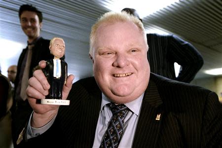 Toronto Mayor Rob Ford shows off his bobblehead doll at City Hall in Toronto November 12, 2013. REUTERS/Aaron Harris