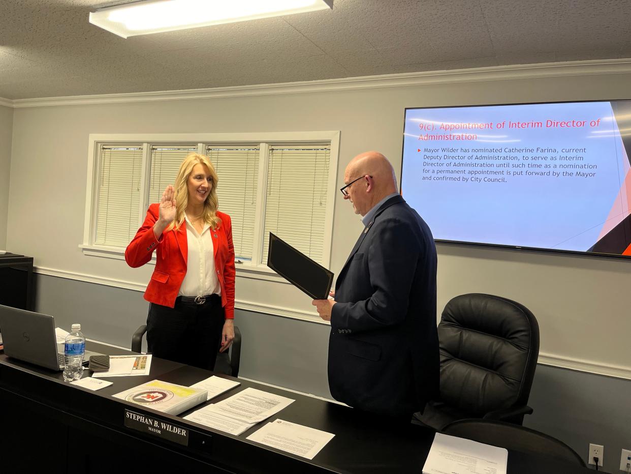 North Canton Mayor Stephan Wilder on March 25 swears in Catherine Farina as the city's interim director of administration. Wilder announced Monday he would appoint Farina to get the permanent position.