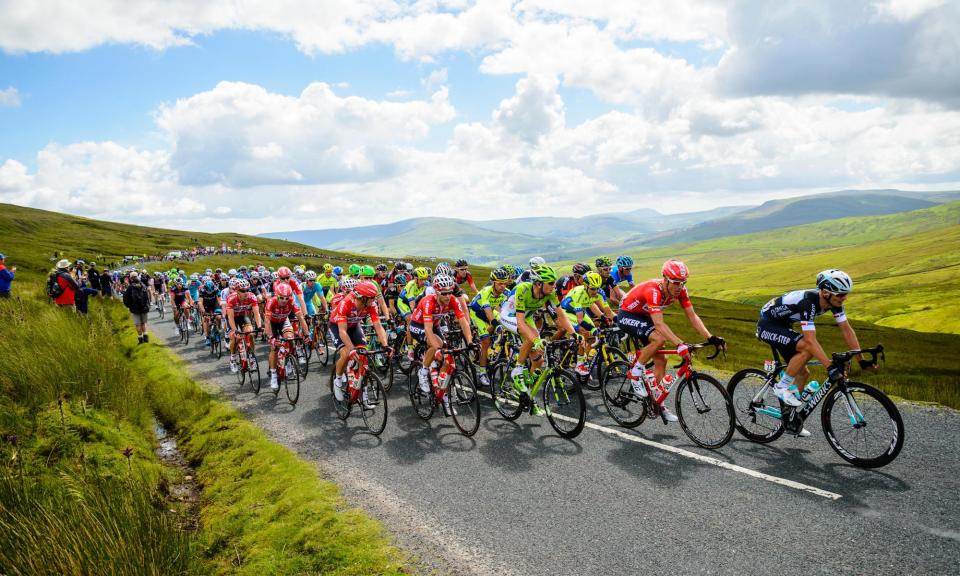 <span>The peloton race over Buttertubs Pass on stage one of the 2014 Tour de France in North Yorkshire.</span><span>Photograph: Jon Sparks/Alamy</span>