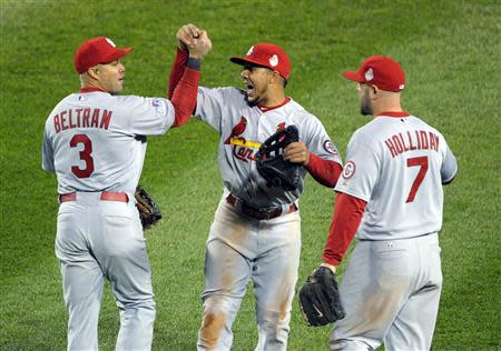 Oct 24, 2013; Boston, MA, USA; St. Louis Cardinals outfielders Carlos Beltran (3) , Jon Jay (19) and Matt Holliday (7) celebrate after game two of the MLB baseball World Series against the Boston Red Sox at Fenway Park. Bob DeChiara-USA TODAY Sports