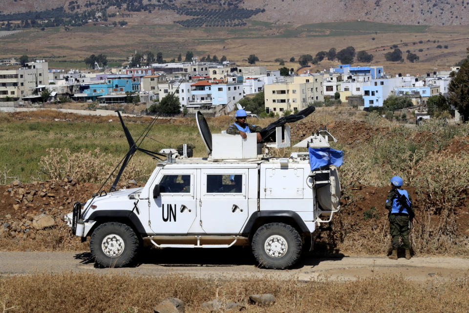 U.N. peacekeepers patrol on the Lebanese side of the Lebanese-Israeli border in the southern village of Wazzani with border village Ghajar in the background, Thursday, July 6, 2023. Israeli forces shelled a southern Lebanese border village on Thursday after several explosions were heard in a disputed area where the borders of Syria, Lebanon and Israel meet. (AP Photo/Mohammad Zaatari)