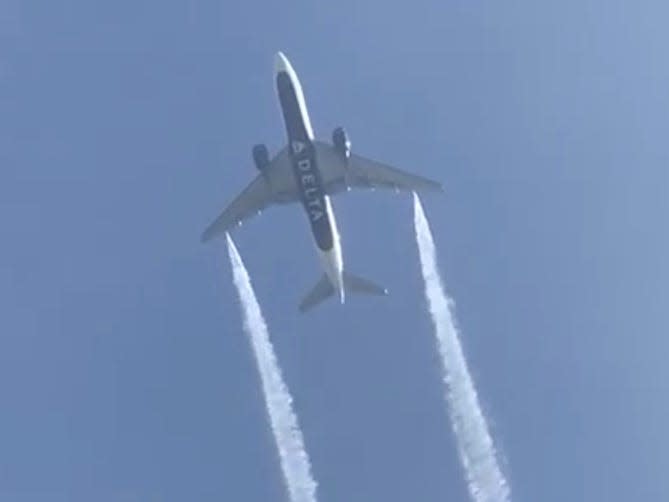 FILE PHOTO: A Delta Airlines, Flight 89, Boeing 777-200 jet empties its fuel tanks as it makes an emergency landing at Los Angeles International Airport, seen from Ocean View Elementary School in Whittier, California, U.S., January 14, 2020 in this still video image obtained by REUTERS 