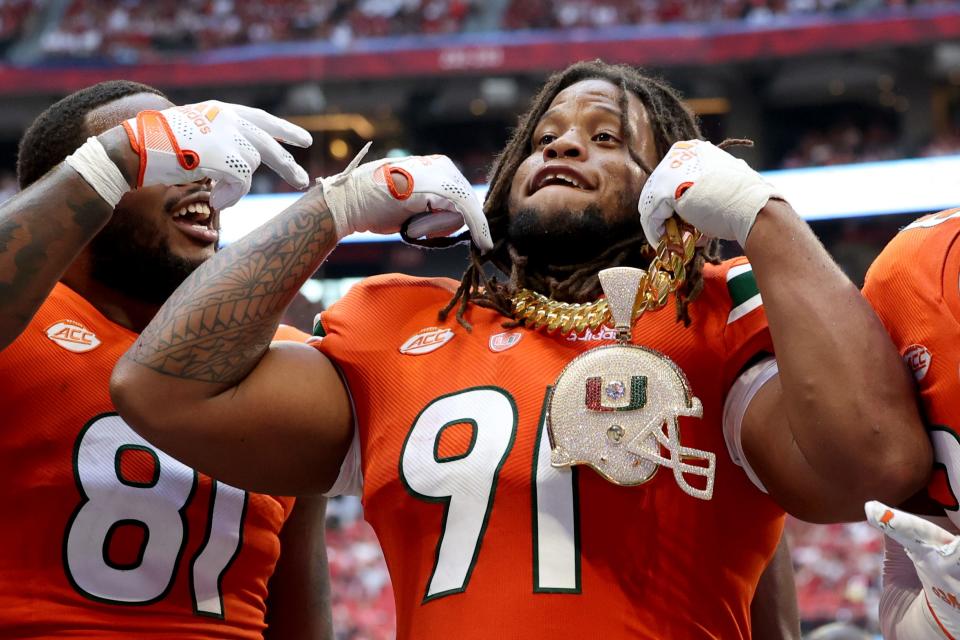 Miami Hurricanes defensive lineman Jordan Miller celebrates with the 2021 turnover chain.