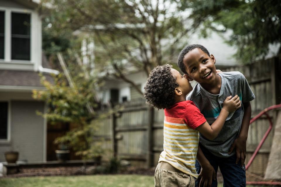 young boys 3 yrs and 6yrs playing in backyard