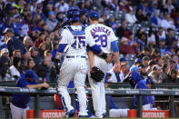 Chicago Cubs catcher Yan Gomes, left, walks with starting pitcher Kyle Hendricks to the dugout during the first inning of the team's baseball game against the New York Mets in Chicago, Thursday, May 25, 2023. (AP Photo/Nam Y. Huh)