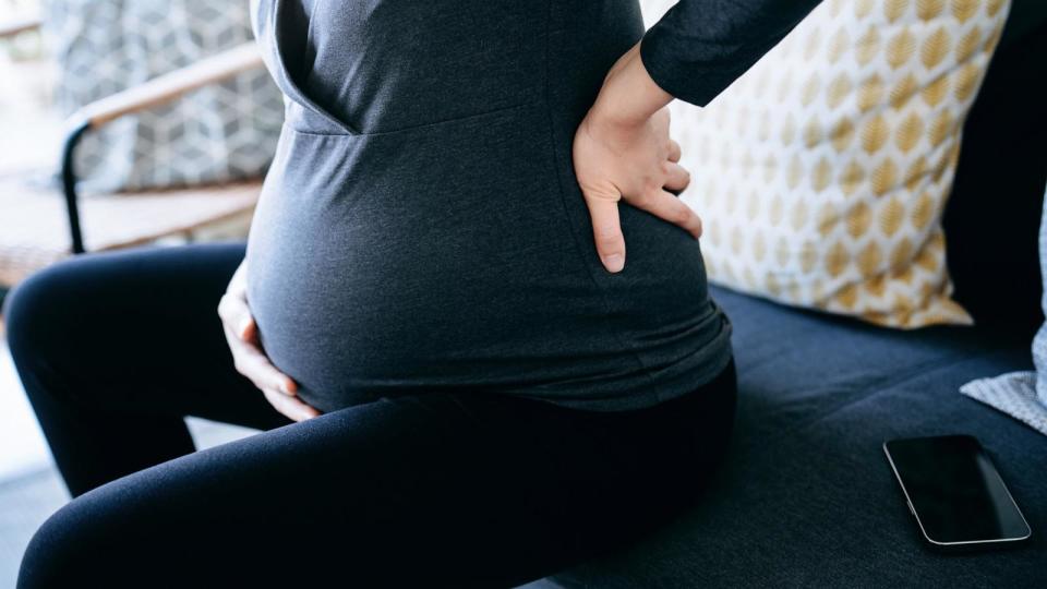 PHOTO: In this undated stock photo, a pregnant woman is seen holding her stomach and lower back. (STOCK PHOTO/Getty Images)