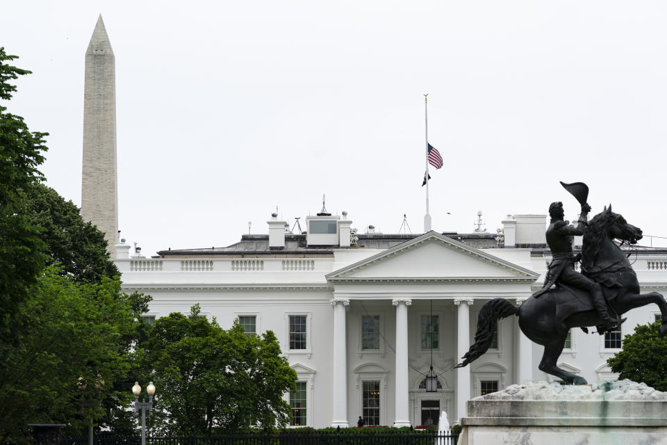 The flags fly at half-staff over the White House by order of President Joe Biden, Wednesday, May 25, 2022, in Washington. (AP Photo/Alex Brandon)