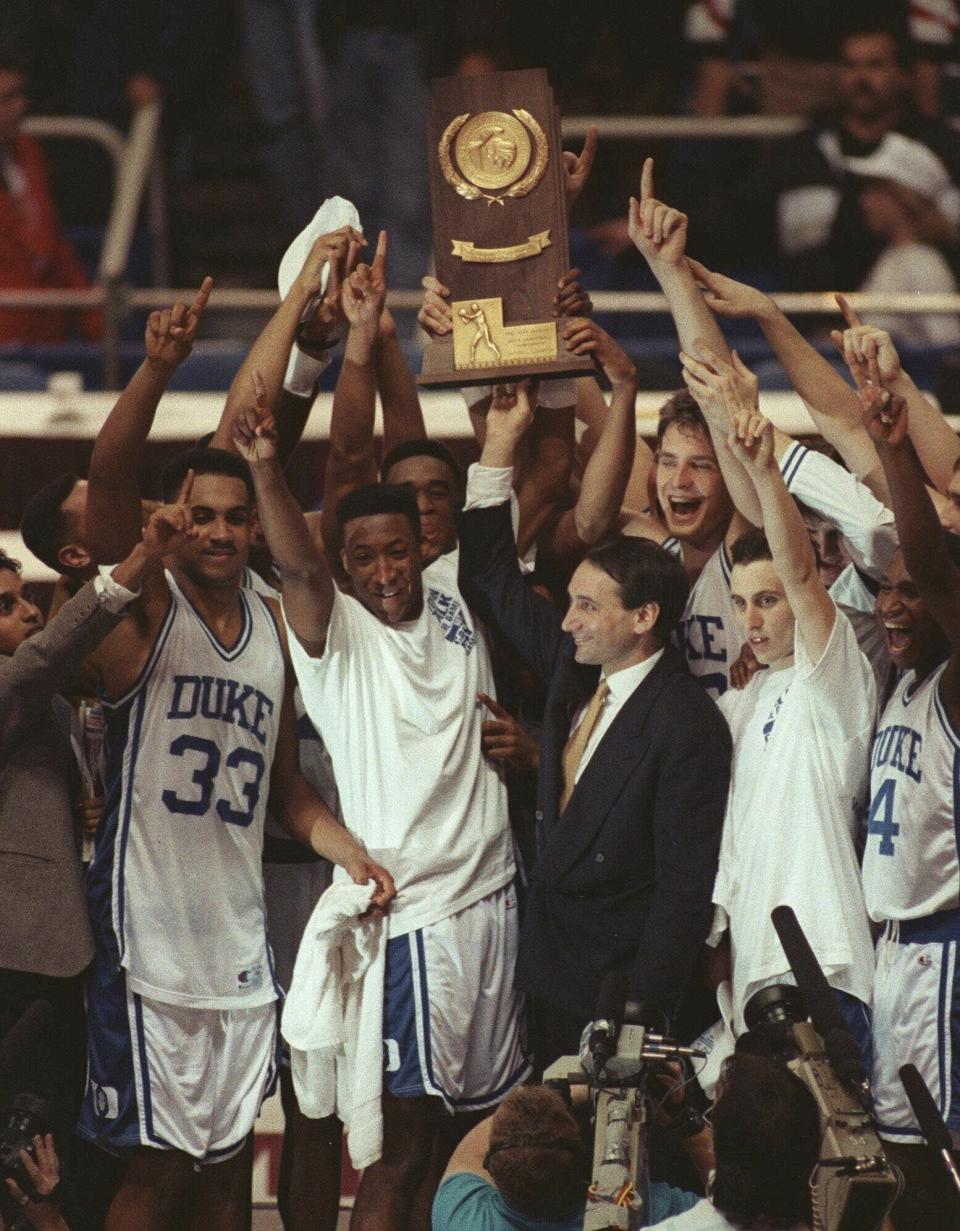 FILE - Duke coach Mike Krzyzewski and his team hold up the NCAA college basketball national championship trophy after defeating Michigan 71-51 in Minneapolis, April 7, 1992. (AP Photo/Jim Mone, File)
