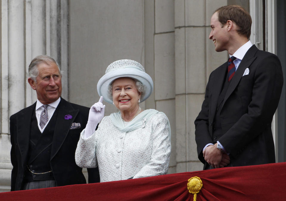 FILE - From left, Britain's Prince Charles, Britain's Queen Elizabeth II and Prince William stand on the balcony at Buckingham Palace during the Diamond Jubilee celebrations in central London Tuesday June 5, 2012. Britain is getting ready for a party featuring mounted troops, solemn prayers — and a pack of dancing mechanical corgis. The nation will celebrate Queen Elizabeth II’s 70 years on the throne this week with four days of pomp and pageantry in central London. (AP Photo/Stefan Wermuth, Pool, File)