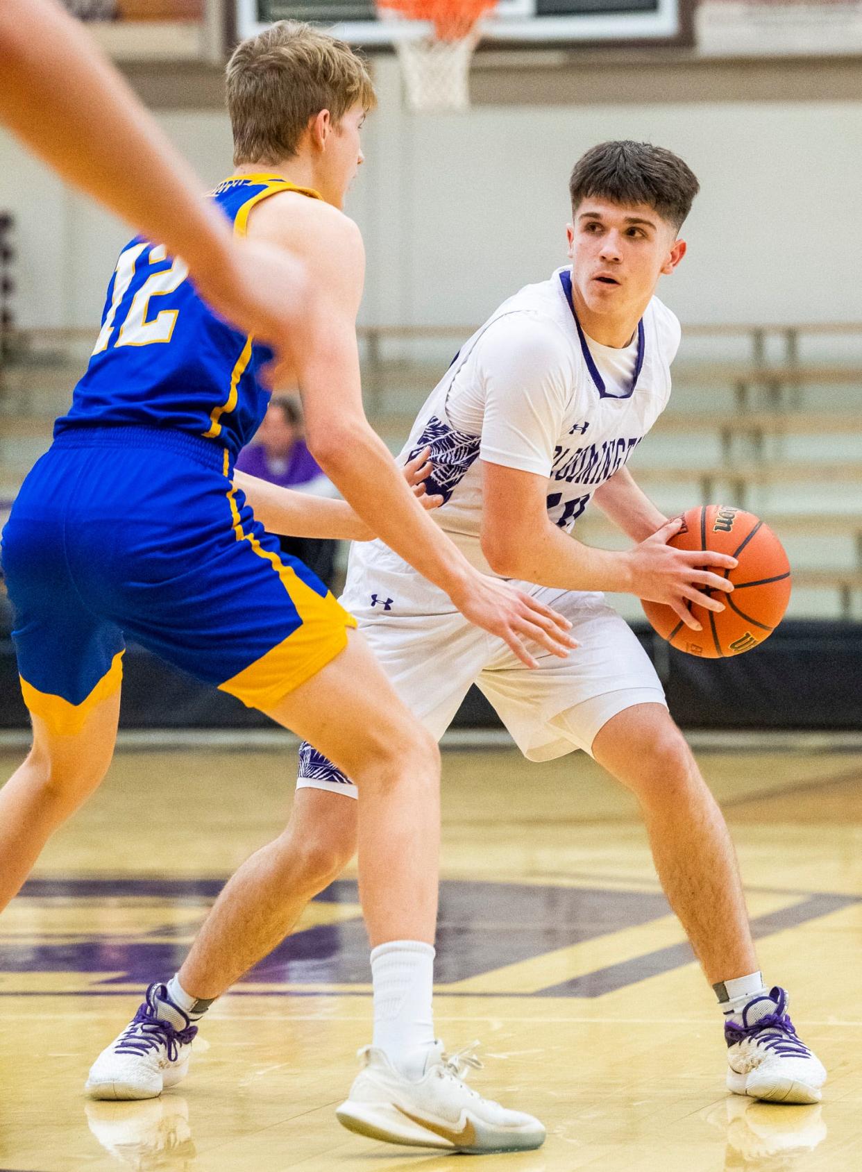 South's Aiden Schmitz (10) looks to pass around Castle's Xander Niehaus (12) during the Bloomington South versus Castle boys' basketball game at Bloomington High School South on Friday, Jan. 20, 2023.