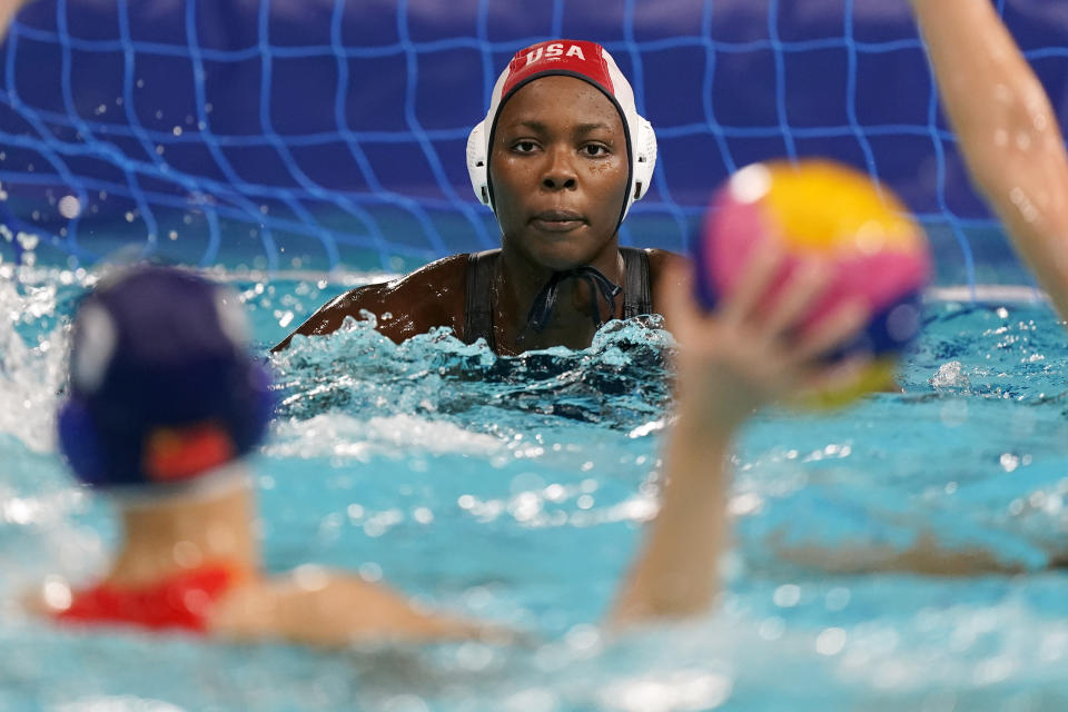 FILE - United States' goalkeeper Ashleigh Johnson watches an attacker during a preliminary round women's water polo match against China at the 2020 Summer Olympics, Monday, July 26, 2021, in Tokyo, Japan. Ashleigh Johnson saw an Olympic future for herself in the water, though she dreamed of being on an Olympic relay team with her siblings. (AP Photo/Mark Humphrey, File)