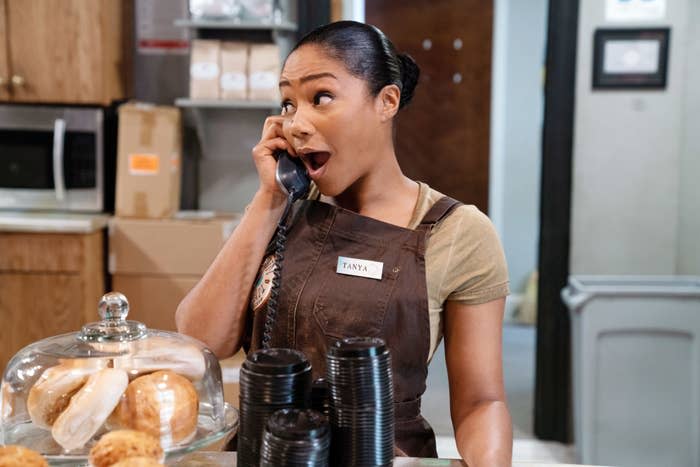 Tiffany Haddish talking on the phone at a coffee shop in "Nobody's Fool"
