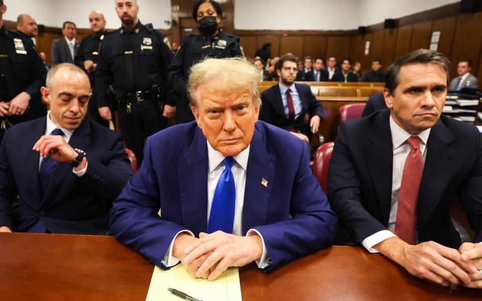 Donald Trump is flanked by lawyers Emil Bove and Todd Blanche during his hush money trial