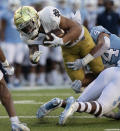 North Carolina's Jeremiah Gemmell (44) stops Notre Dame's Kyren Williams during the first quarter of an NCAA college football game Friday, Nov. 27, 2020, in Chapel Hill, N.C. (Robert Willett/The News & Observer via AP, Pool)