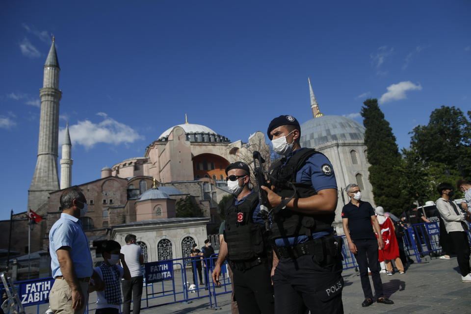 Turkish armed police officers, following Turkey's Council of State's decision, patrol outside the Byzantine-era Hagia Sophia, one of Istanbul's main tourist attractions in the historic Sultanahmet district of Istanbul, Friday, July 10, 2020. Turkey's highest administrative court issued a ruling Friday that paves the way for the government to convert Hagia Sophia - a former cathedral-turned-mosque that now serves as a museum - back into a Muslim house of worship. The Council of State threw its weight behind a petition brought by a religious group and annulled a 1934 cabinet decision that changed the 6th century building into a museum. (AP Photo/Emrah Gurel)