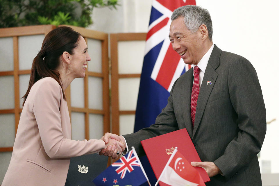 New Zealand's Prime Minister Jacinda Ardern, left, shakes hands with Singapore's Prime Minister Lee Hsien Loong after signing a joint declaration for enhanced partnership at the Istana or presidential palace in Singapore, Friday, May 17, 2019. (AP Photo/Yong Teck Lim)