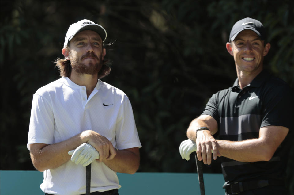 Rory McIlroy of Northern Ireland, right, speaks with Tommy Fleetwood of England as they wait at the second tee off during the first round of the WGC-Mexico Championship golf tournament, at Chapultepec Golf Club in Mexico City, Mexico City, Thursday, Feb. 20, 2020.(AP Photo/Fernando Llano)
