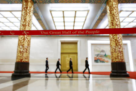 Communist Party spokesman Tuo Zhen and other officials arrive at a media briefing one day ahead of the opening of the 19th National Congress of the Communist Party of China, at the Great Hall of the People in Beijing, October 17, 2017. REUTERS/Thomas Peter