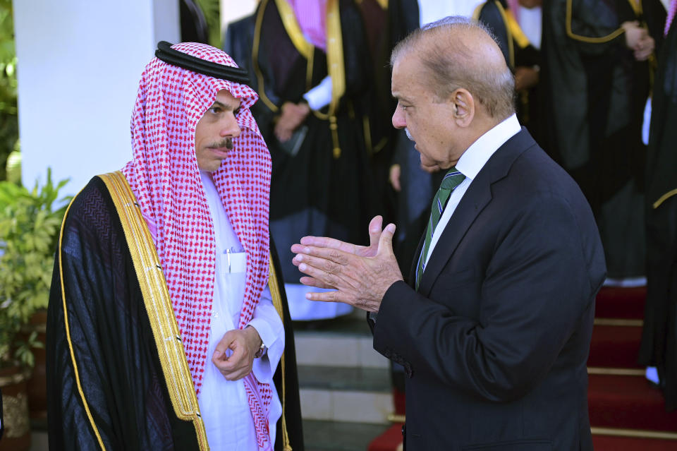 In this photo released by Prime Minister Office, visiting Saudi Foreign Minister Prince Faisal bin Farhan, left, listens to Pakistan's Prime Minister Shehbaz Sharif after their meeting, in Islamabad, Pakistan, Tuesday, April 16, 2024. The Saudi Arabia's foreign minister led a high-level delegation on a two-day visit to Pakistan, which is seeking help in overcoming one of its worst economic crises. (Prime Minister Office via AP)