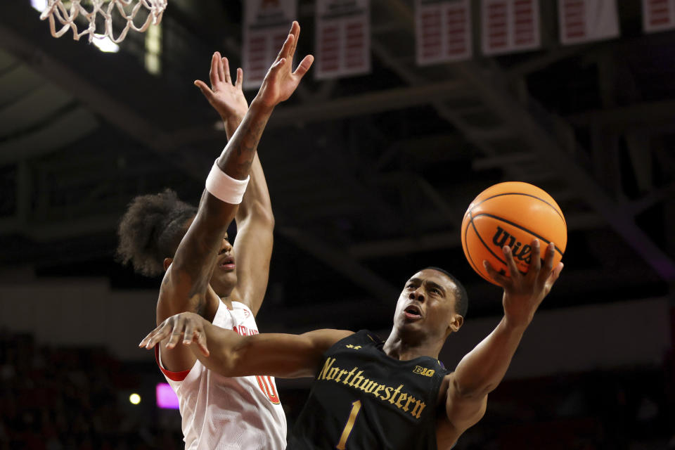 Northwestern guard Chase Audige (1) shoots past Maryland forward Julian Reese (10) during the first half of an NCAA college basketball game, Sunday, Feb. 26, 2023, in College Park, Md. (AP Photo/Julia Nikhinson)