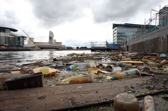 Plastic bottles, balls and floating trash pollutes Manchester Ship Canal in England.