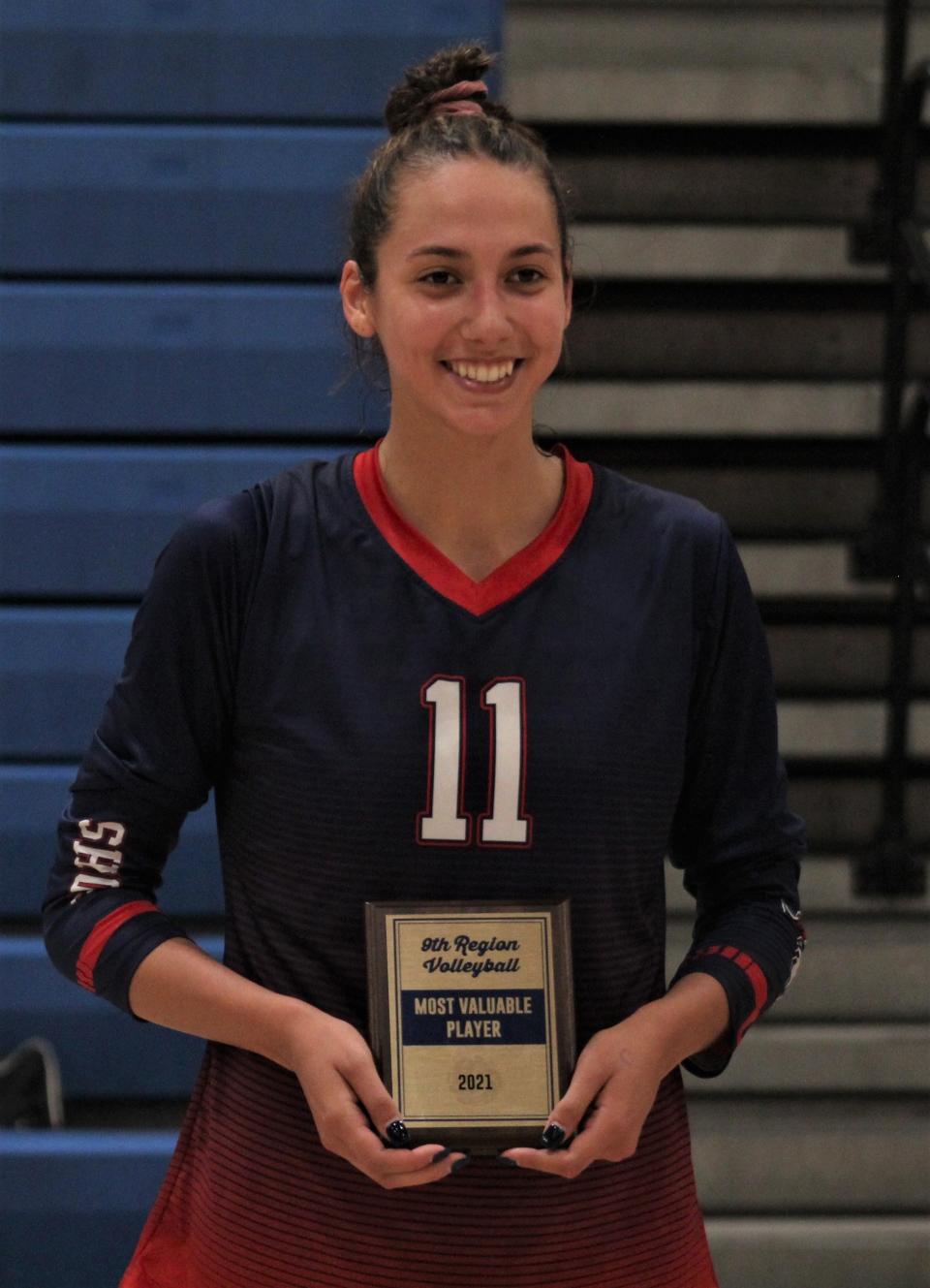 St. Henry senior Taylor Preston shows her plaque for tournament MVP as St. Henry defeated Notre Dame 3-1 (25-21, 25-22, 16-24, 25-22) in the KHSAA Ninth Region volleyball championship Oct. 28.