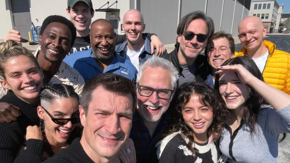 The cast of the movie Superman all gathered together smiling at the camera.