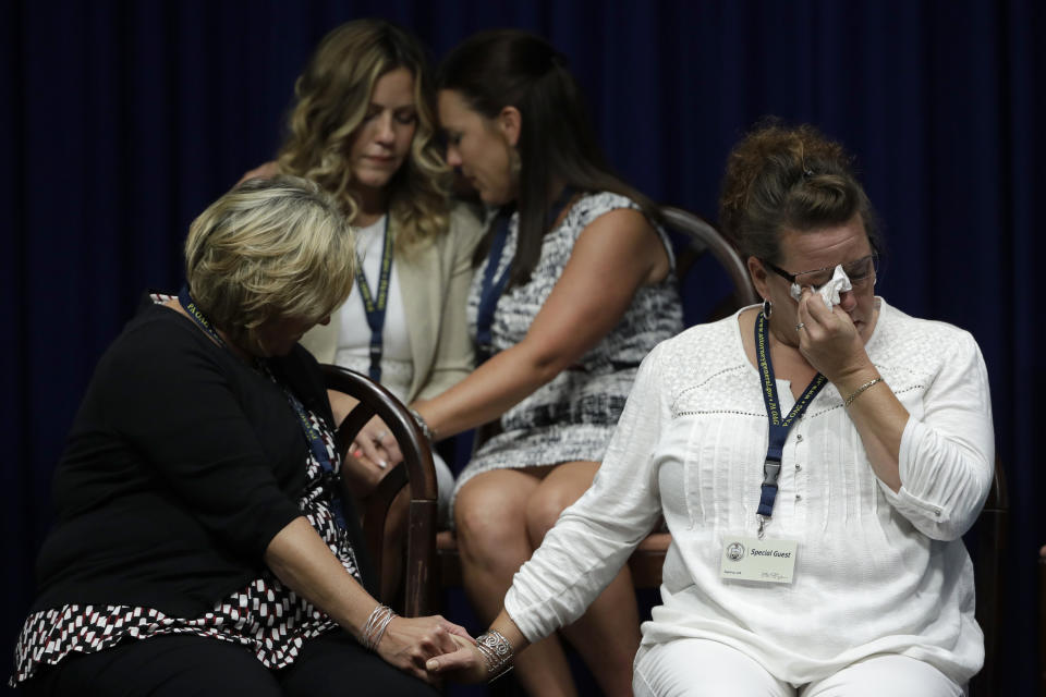 FILE - In this Aug. 14, 2018 file photo, victims of clergy sexual abuse, or their family members, react as Pennsylvania Attorney General Josh Shapiro speaks during a news conference at the State Capitol in Harrisburg, Pa. Two years ago, U.S. attorney William McSwain in Philadelphia joined the long line of ambitious prosecutors investigating the Roman Catholic church's handling of priest-abuse complaints. The Justice Department had never brought a conspiracy case against the church. McSwain sent subpoenas to dioceses across Pennsylvania asking them to turn over their files and submit to grand jury testimony if asked. The dioceses pledged to comply. But as McSwain's tenure nears its end as President-elect Joe Biden takes office next month, there's no sign that any sweeping church indictment is afoot. (AP Photo/Matt Rourke, File)