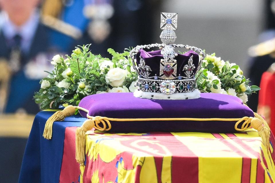 The coffin of Queen Elizabeth II, adorned with a Royal Standard and the Imperial State Crown and pulled by a Gun Carriage of The King's Troop Royal Horse Artillery, is pictured during a procession from Buckingham Palace to the Palace of Westminster, in London on Sept. 14, 2022.