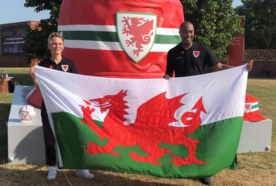 Welsh ambassadors Jess Fishlock and Colin Jackson at the giant bucket hat sculpture in Doha, Qatar.