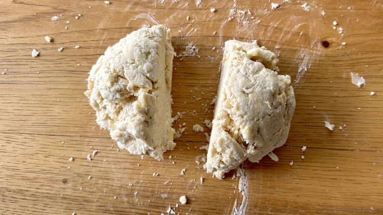 two pieces of pie dough on cutting board