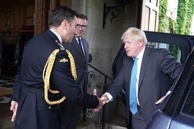 <p>Andrew Milligan - WPA Pool/Getty</p> Prime Minister Boris Johnson is greeted by Lieutenant Colonel Tom White at Balmoral Castle on September 6, 2022