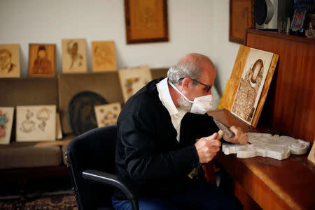 Christian artist and sculptor Naser Jeldha crafts a sculpture in his studio in Gaza City December 4, 2016. REUTERS/Suhaib Salem