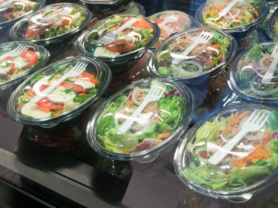 Pre-packaged salads in a grocery store.