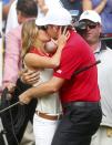 REFILE - CORRECTING IDENTITY OF COUPLE Keegan Bradley of the U.S. kisses girlfriend Jillian Stacey after he and playing partner Phil Mickelson won their four ball match against Ernie Els of South Africa and Brendon de Jonge of Zimbabwe at the 2013 Presidents Cup golf tournament at Muirfield Village Golf Club in Dublin, Ohio October 5, 2013. REUTERS/Chris Keane (UNITED STATES - Tags: SPORT GOLF)