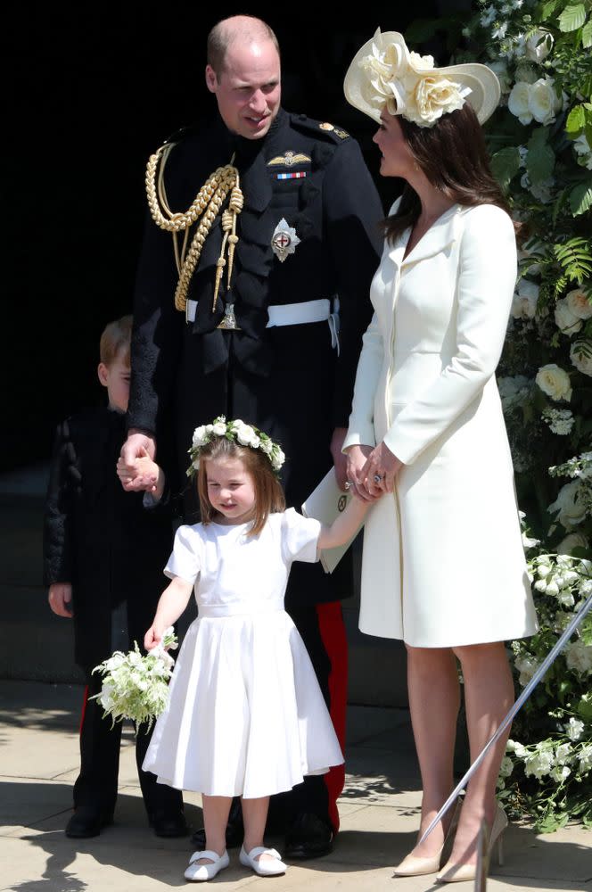 Princess Charlotte and Prince George (behind Prince Willam) with Princess Kate at the wedding of Meghan and Harry.