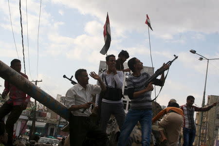 Pro-government fighters open fire into the air to celebrate after they took the Bir Basha neighborhood from Houthi fighters in Yemen's southwestern city of Taiz March 11, 2016. REUTERS/Anees Mahyoub