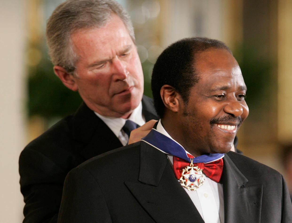 President George W. Bush awards Paul Rusesabagina, who sheltered people at a hotel he managed during the Rwandan genocide in 1994, the Presidential Medal of Freedom at the White House on Nov. 9, 2005.