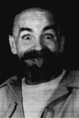 FILE PHOTO - Charles Manson clowns around as he is led to his cell upon the conclusion of his exclusive interview with Reuters August 25, 1989. REUTERS/File Photo