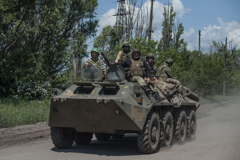 Ukrainian soldiers ride an APC on the frontline near Bakhmut, the site of fierce battles with the Russian troops in the Donetsk region, Ukraine, Monday, June 5, 2023. (Iryna Rybakova via AP)