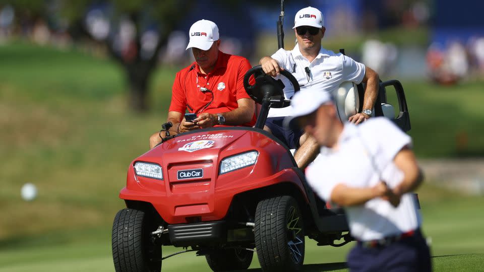Johnson watches Justin Thomas during a practice round. - Carl Recine/Reuters