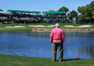 <p>Arnold Palmer of the United States standing watching the golf beside the 18th hole during the first round of the 2013 Arnold Palmer Invitational Presented by Mastercard at Bay Hill Golf and Country Club on March 21, 2013 in Orlando, Florida. (Photo by David Cannon/Getty Images) </p>