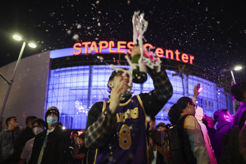 Los Angeles Lakers fans celebrate outside of Staples Center, Sunday, Oct. 11, 2020, in Los Angeles, after the Lakers defeated the Miami Heat in Game 6 of basketball's NBA Finals to win the championship. (AP Photo/Christian Monterrosa)