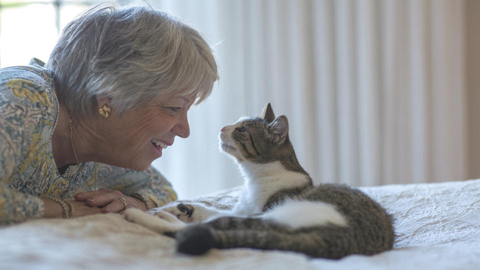 old lady smiling at cat