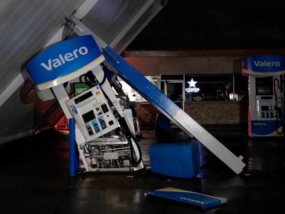 valeros gas pump leaning over underneath collapsed gas station roof