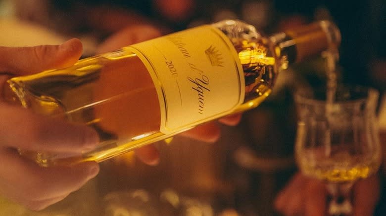 pouring sauternes wine from bottle