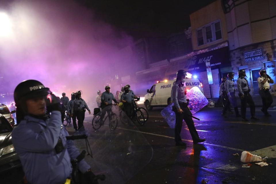 Police clear a section of 52nd Street in West Philadelphia early Tuesday, Oct. 27, 2020. Protesters gathered after police shot and killed a Black man in West Philadelphia on Monday. (Tim Tai/The Philadelphia Inquirer via AP)