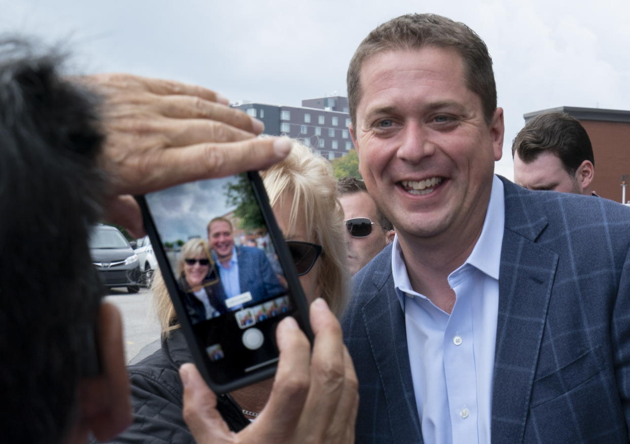 A supporter has a photo taken with Conservative leader Andrew Scheer at a campaign rally in Trois-Rivieres, Que. on Wednesday, September 11, 2019. THE CANADIAN PRESS/Paul Chiasson/The Canadian Press via AP)