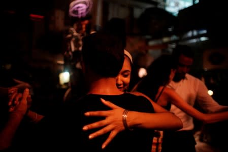 People dance tango in an art gallery in Old Havana